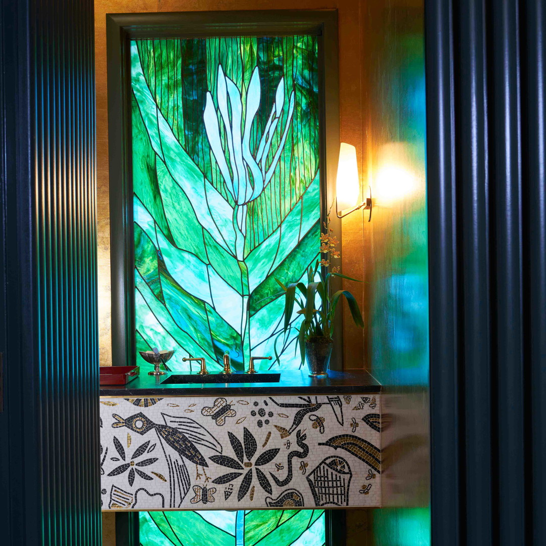 a bathroom with a large stained glass window
