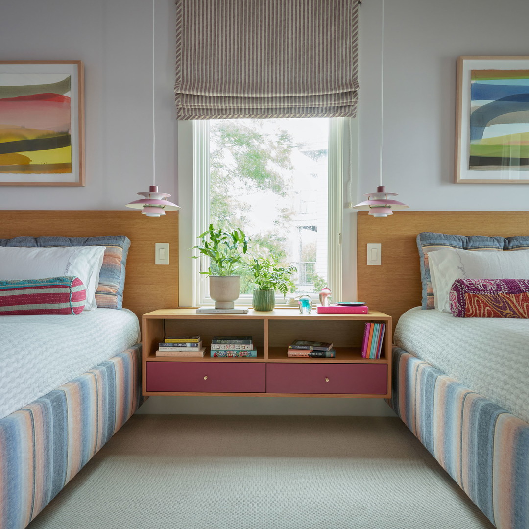 a couple of beds sitting next to each other in a bedroom