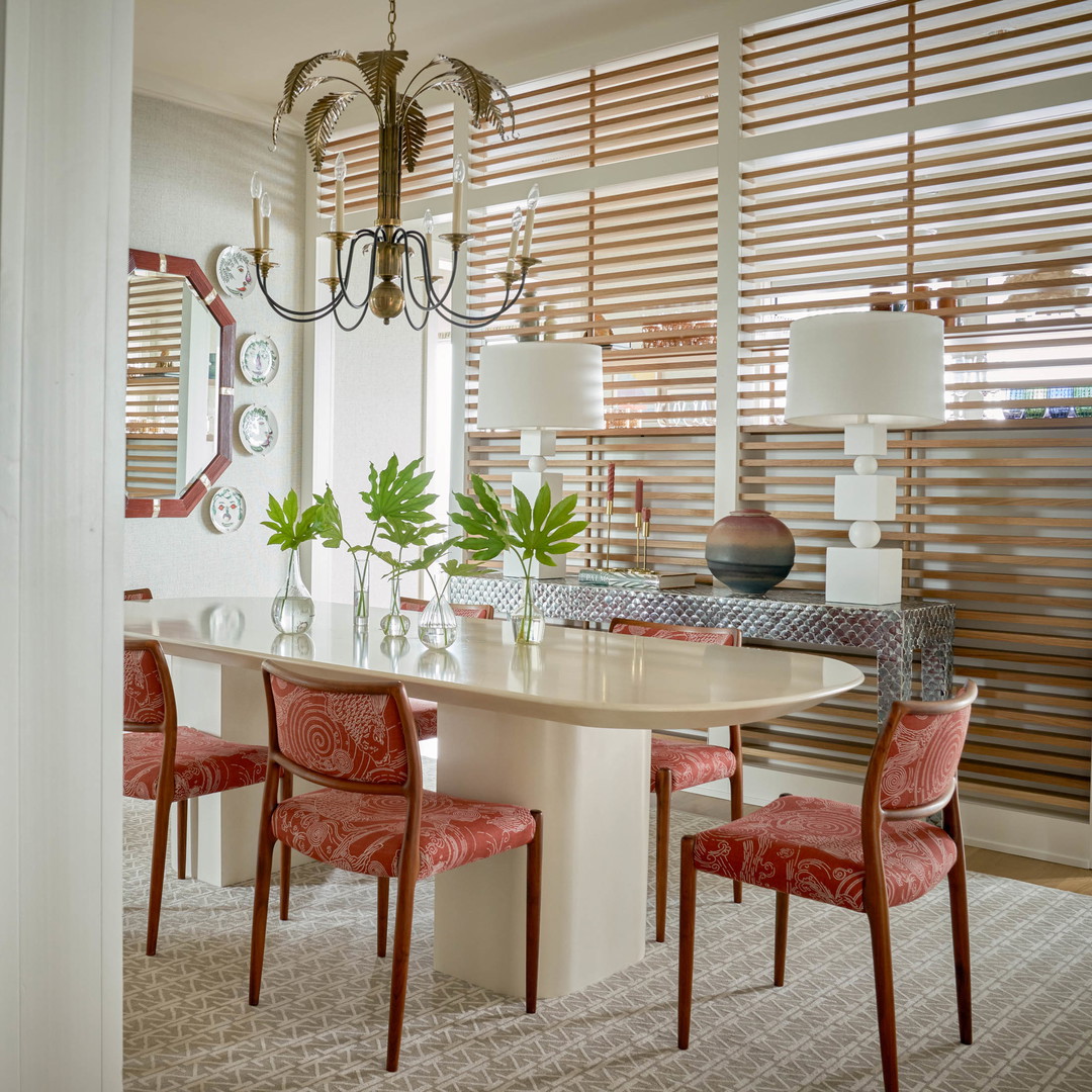 a dining room with a table, chairs and a chandelier