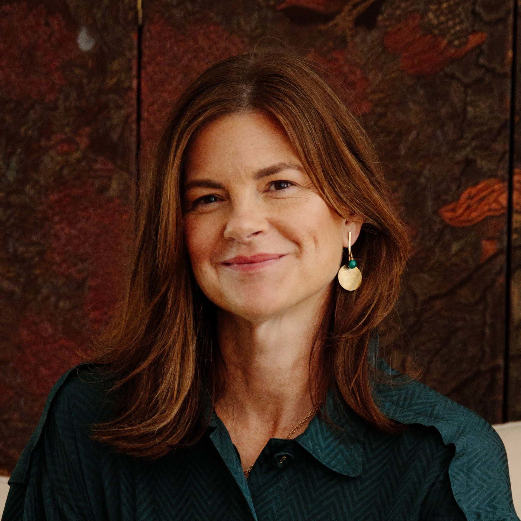 a woman sitting on a couch next to a table
