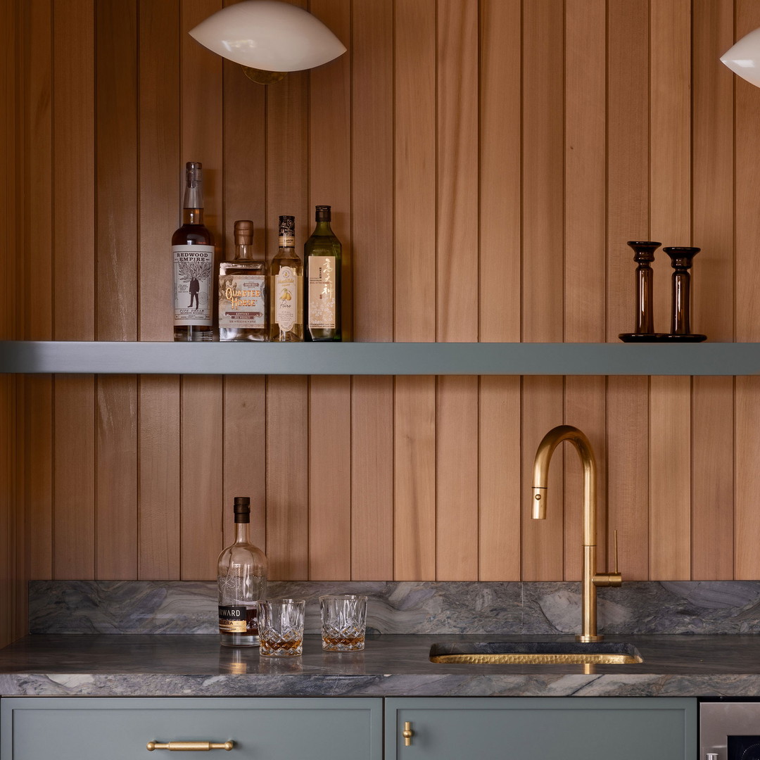 a kitchen with a marble counter top next to a wine rack