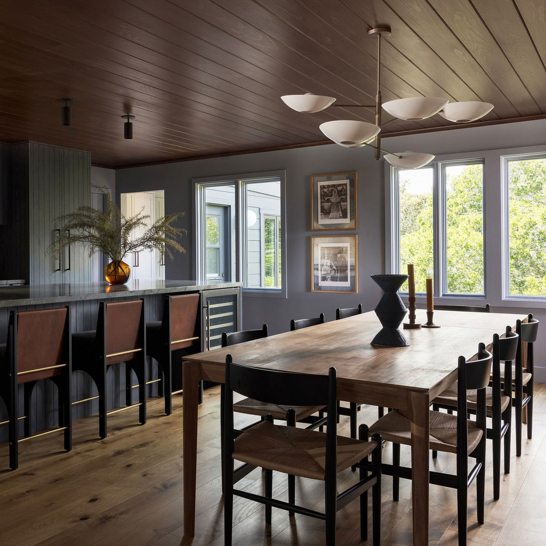 a large kitchen with a wooden table and chairs