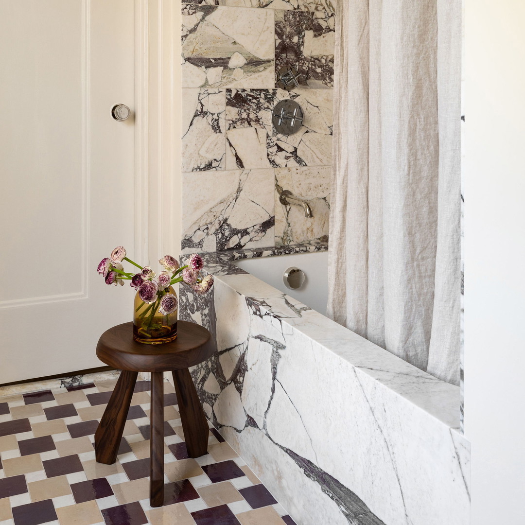 a bathroom with a checkered floor and marble walls