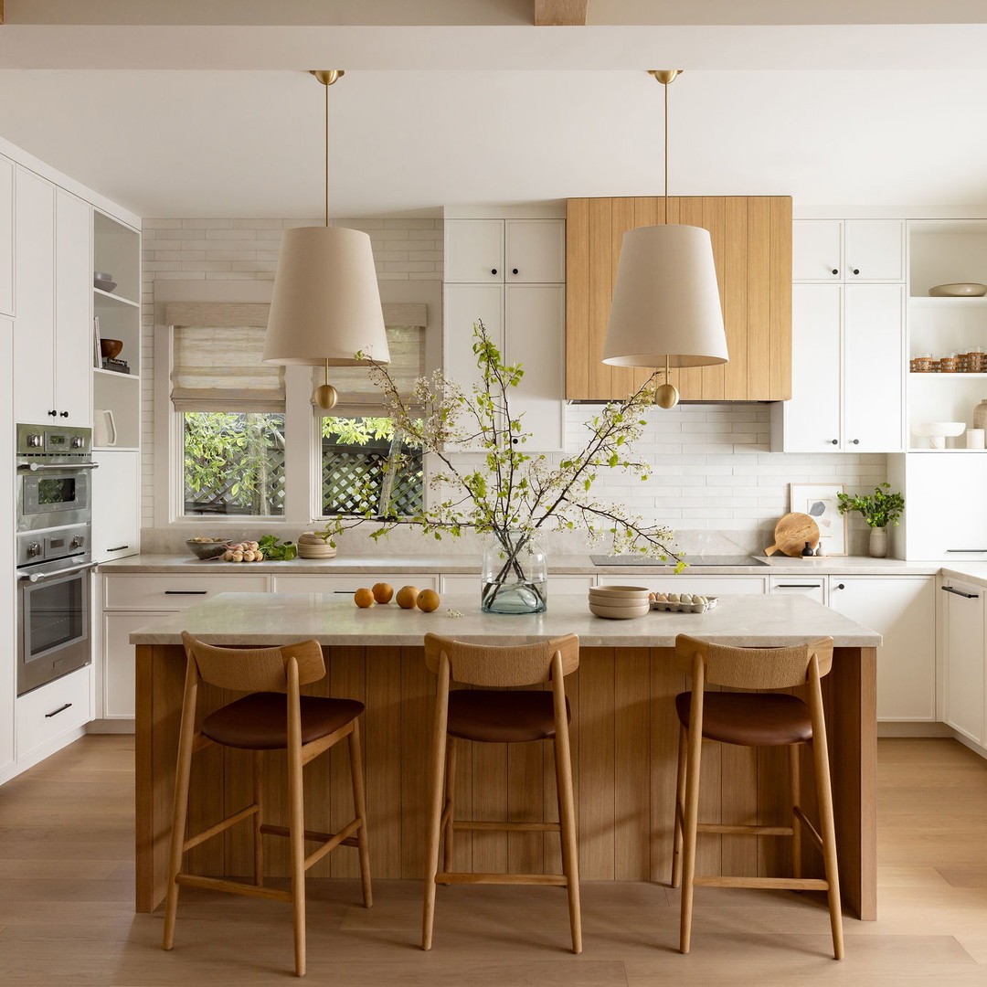 a kitchen with a center island with stools