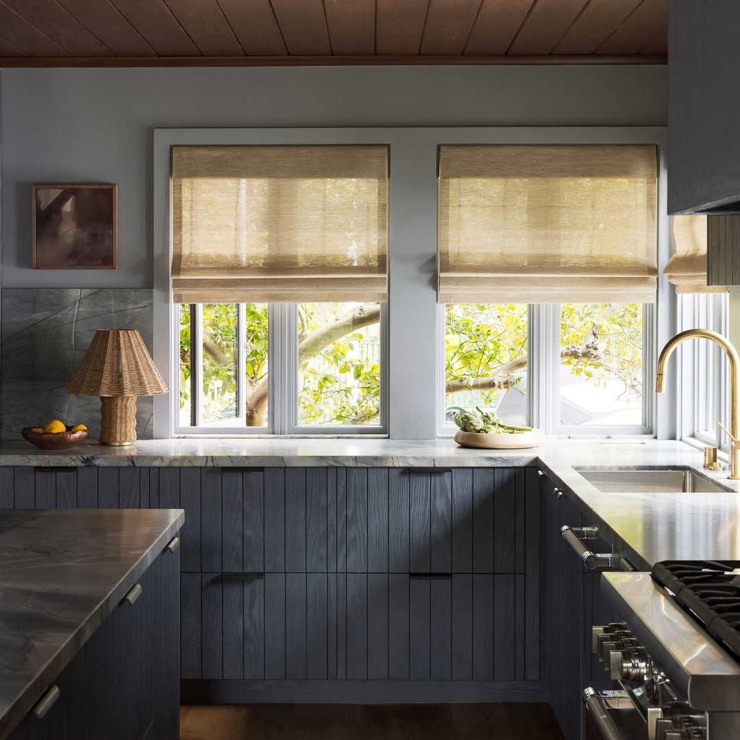 a kitchen with a stove top oven next to a window