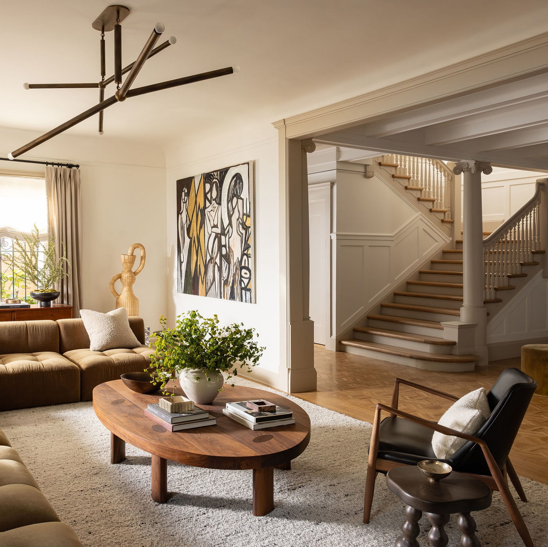 a living room filled with furniture and a staircase