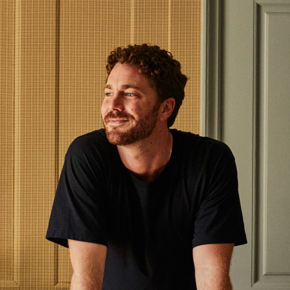 a man sitting on a couch in a living room