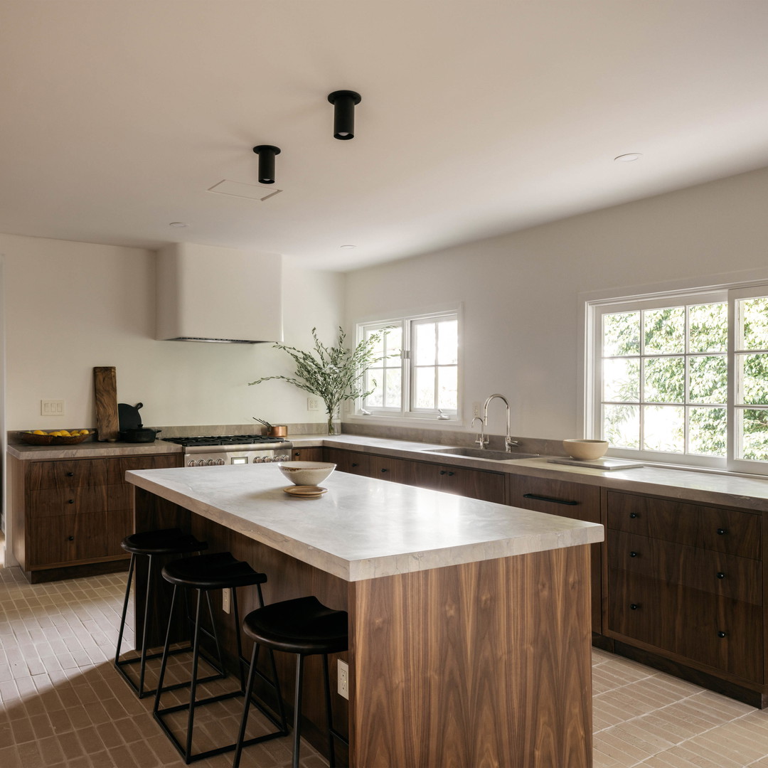 a large kitchen with a center island with stools