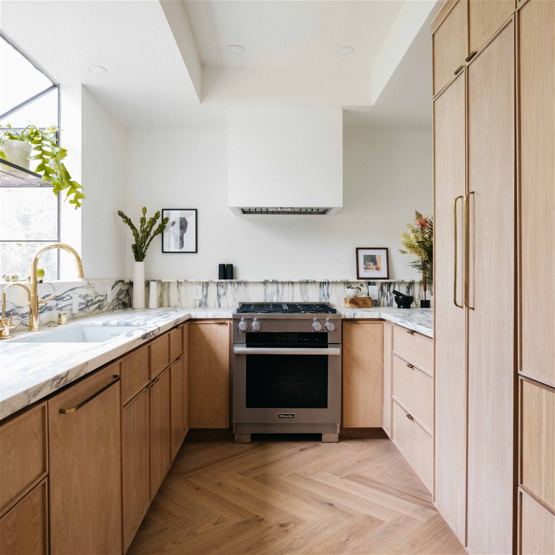 a kitchen with wooden cabinets and a stainless steel stove