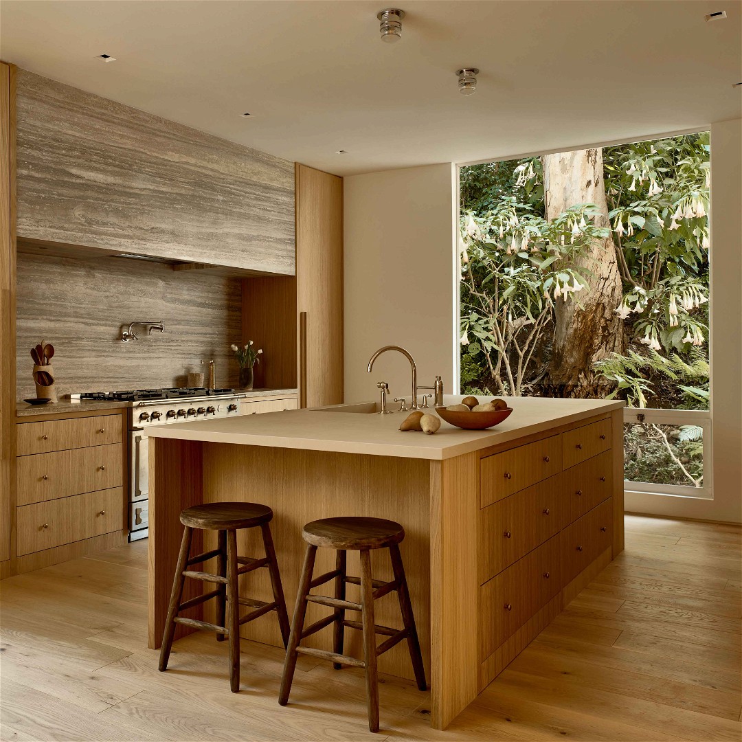 a kitchen with a center island surrounded by stools