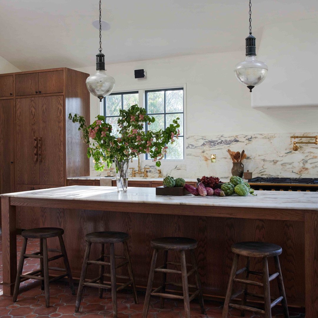 a kitchen with a center island with stools