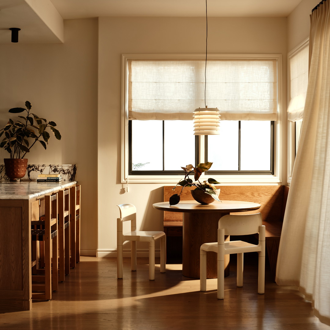 a dining room with a table and chairs