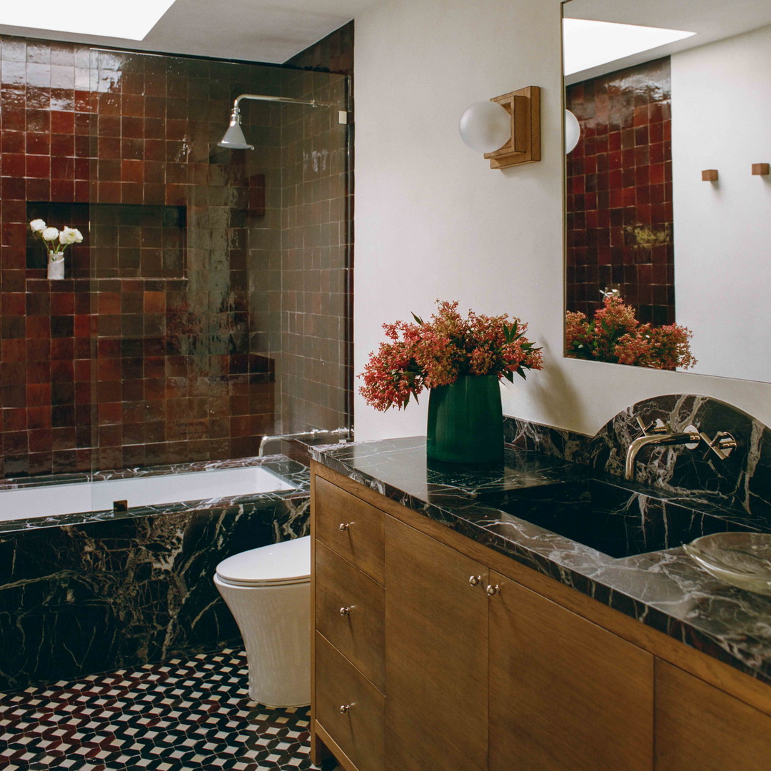 a bathroom with a black and white checkered floor