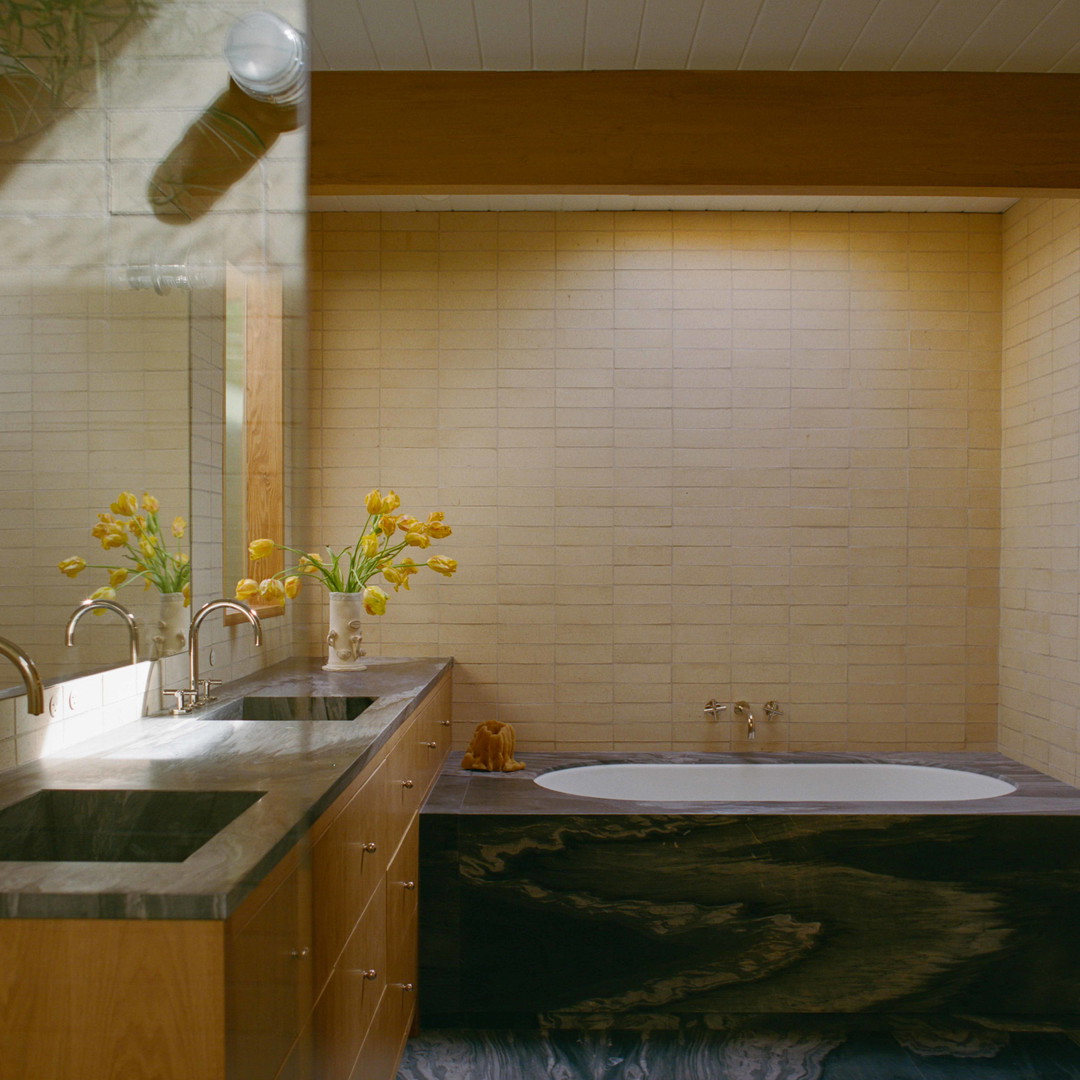 a bathroom with two sinks and a bathtub