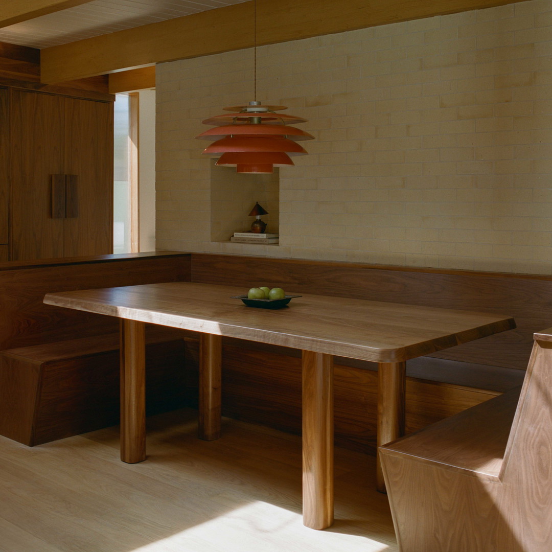 a wooden table and bench in a room