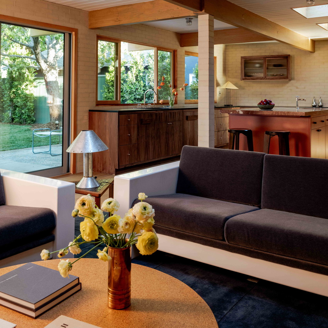 a living room filled with furniture and a large window
