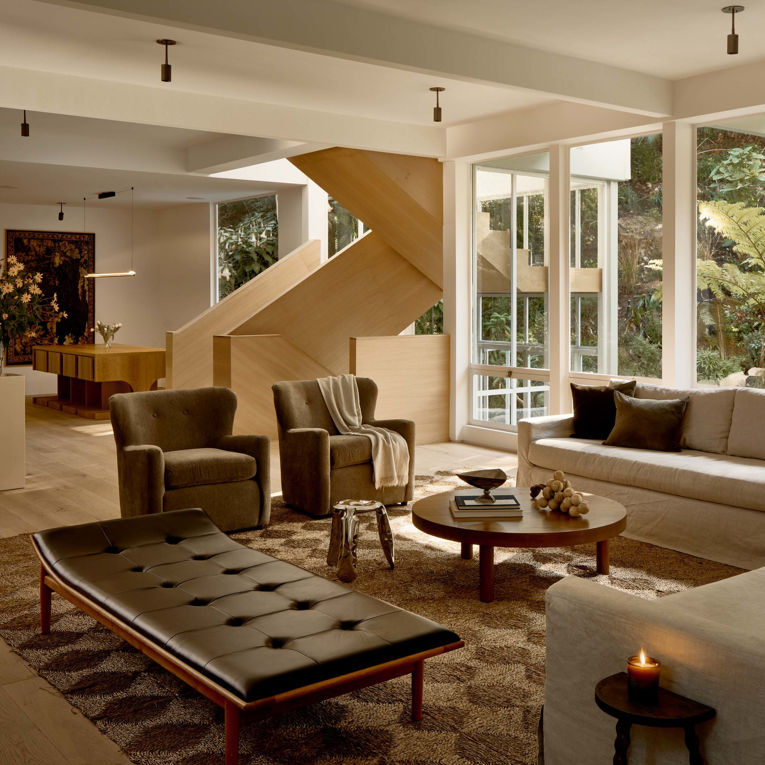 a living room filled with furniture and lots of windows