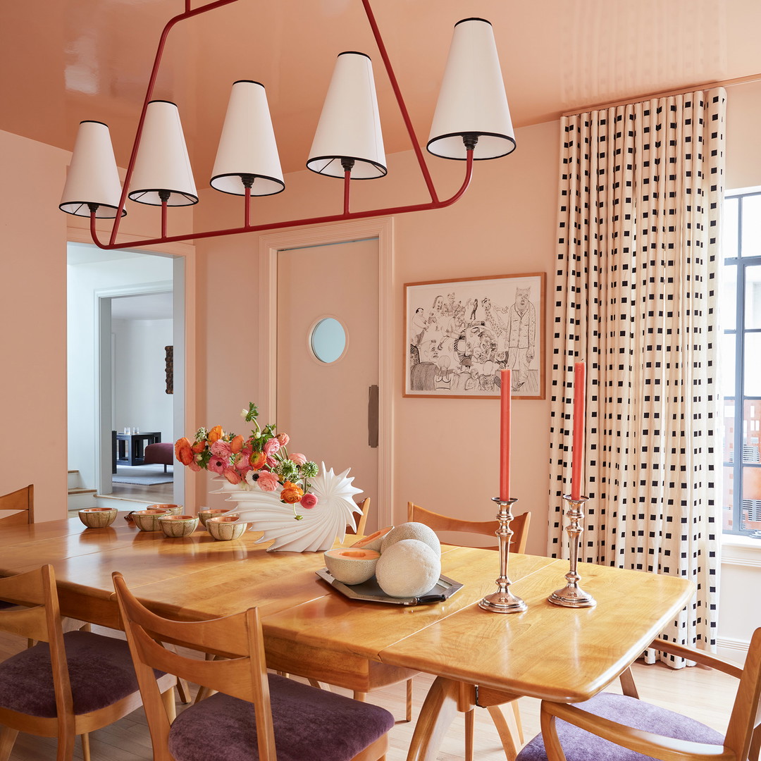 a dining room with a wooden table and purple chairs