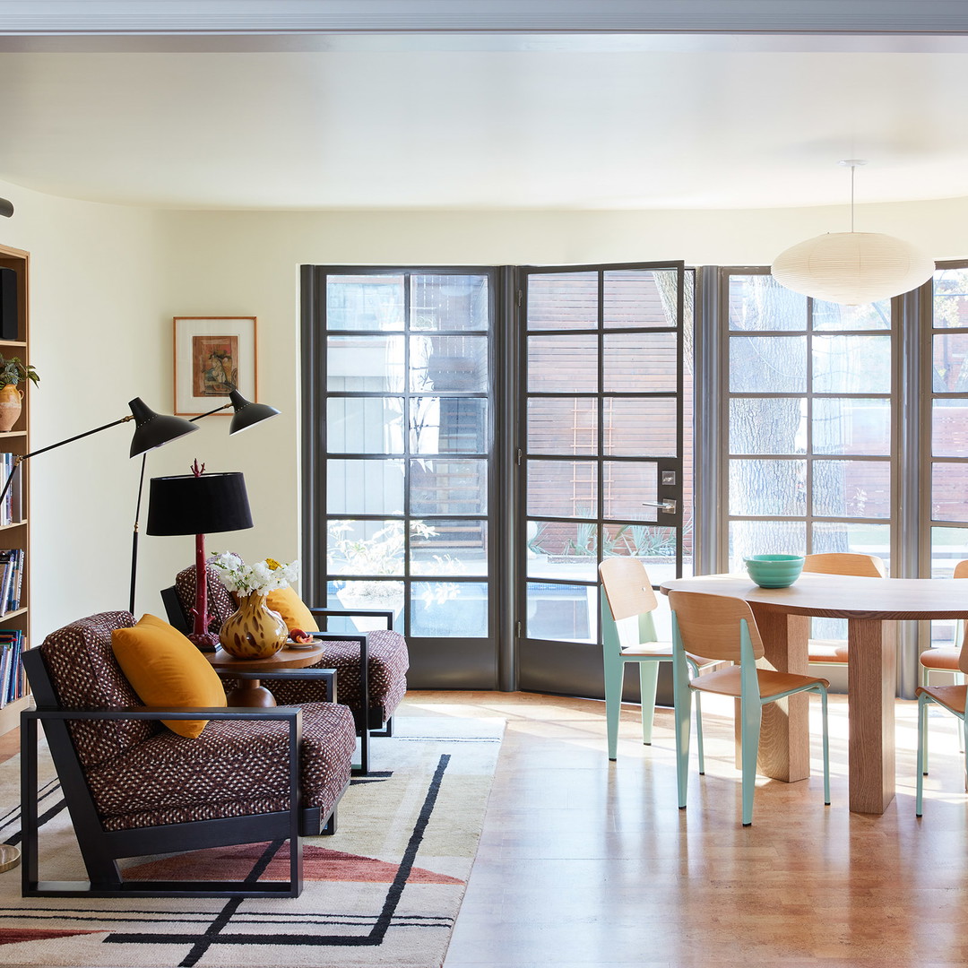 a living room filled with furniture and lots of windows