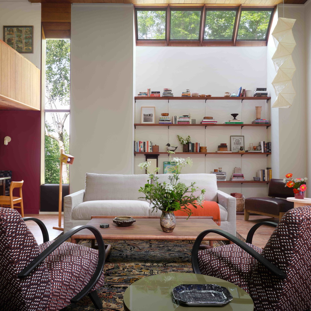 a living room filled with furniture and lots of windows