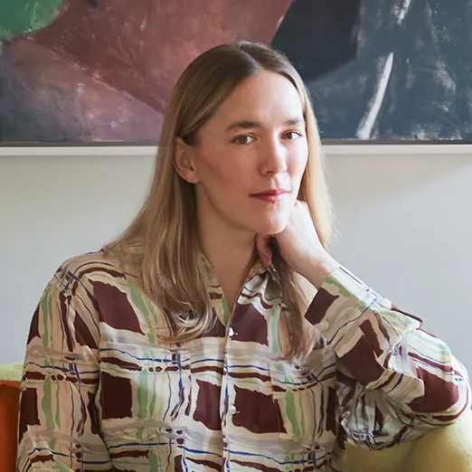 a woman sitting on a couch in a living room