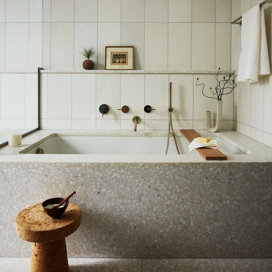 a bathroom with a bathtub and a stool