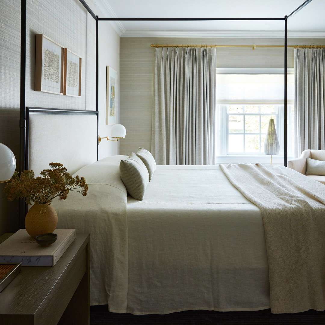 a bedroom with a four poster bed and curtains