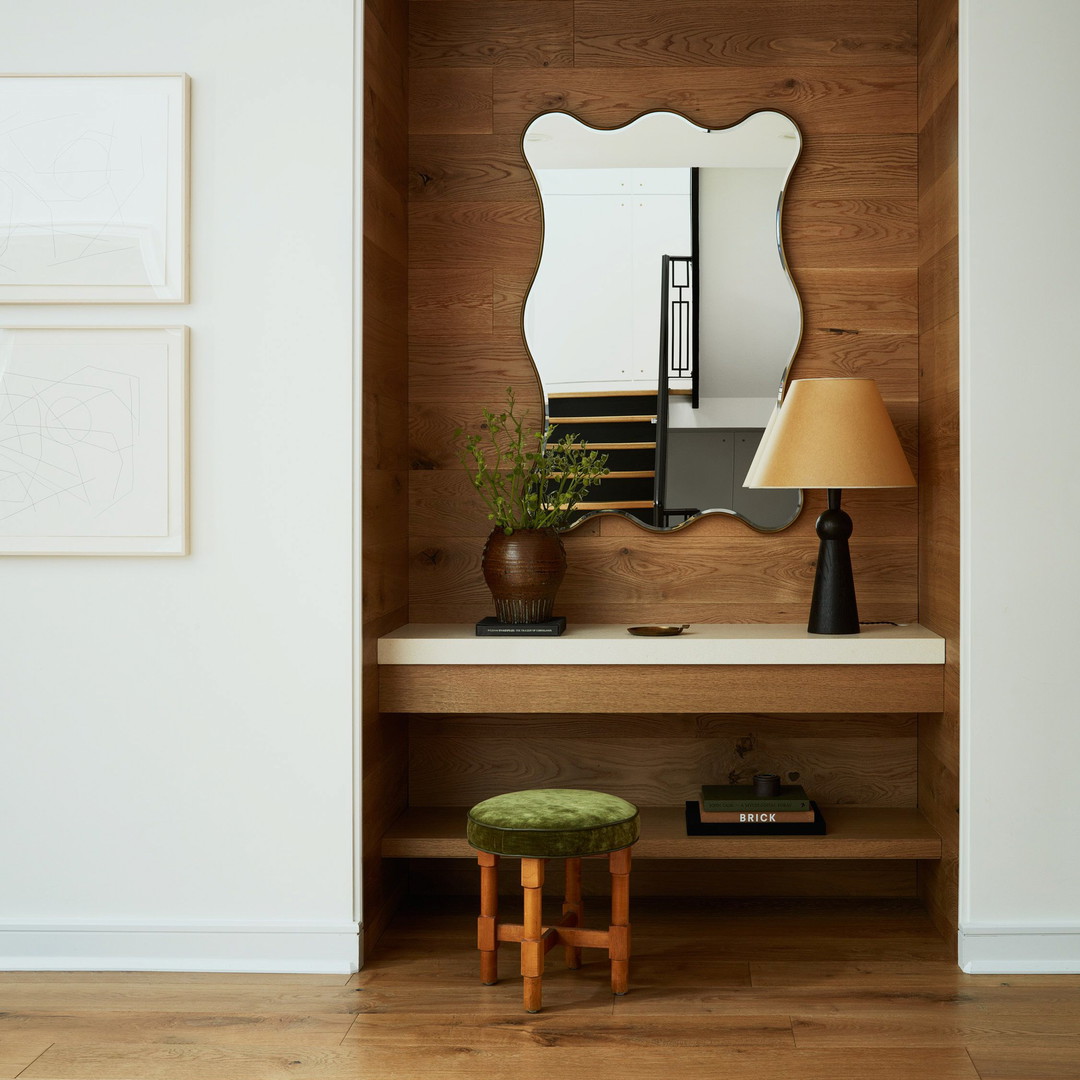 a wooden shelf with a mirror and a stool