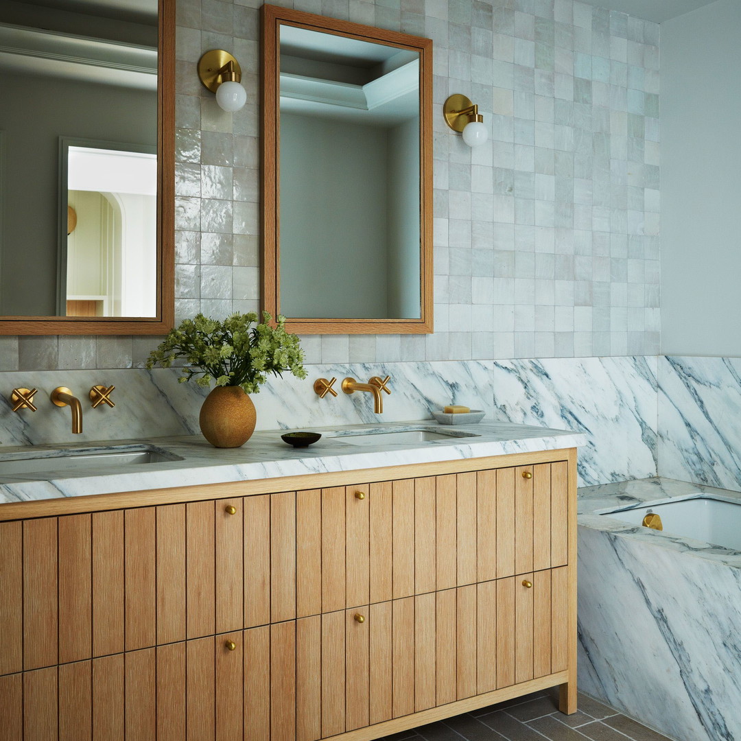 a bathroom with two sinks and a large mirror