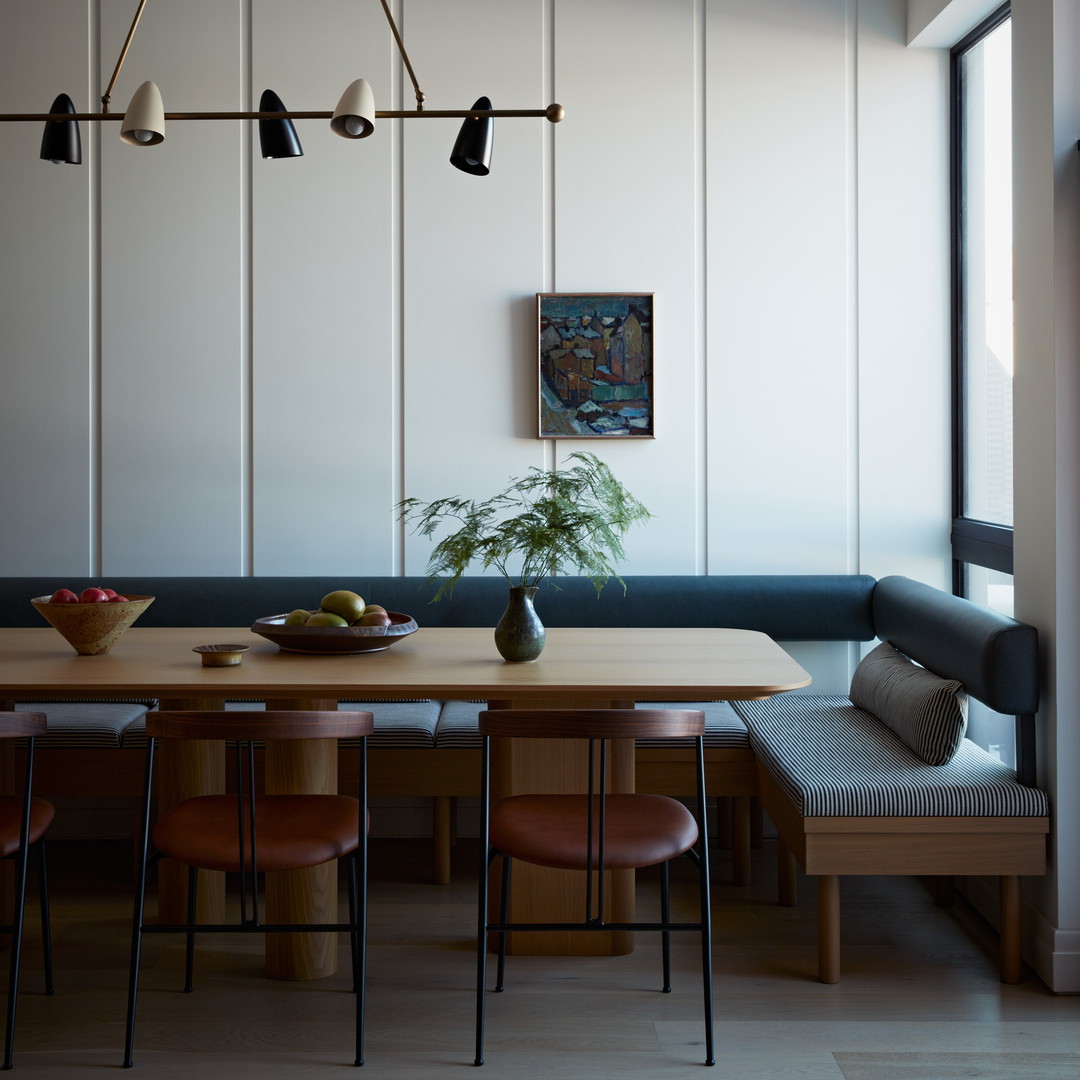 a dining room with a wooden table surrounded by chairs