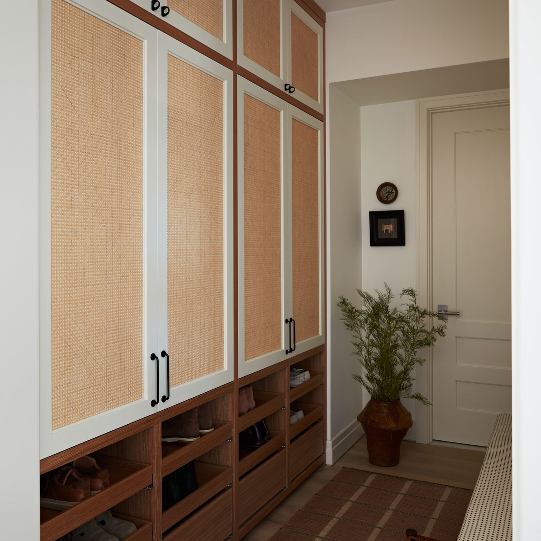 a room with a large wooden cabinet and a plant