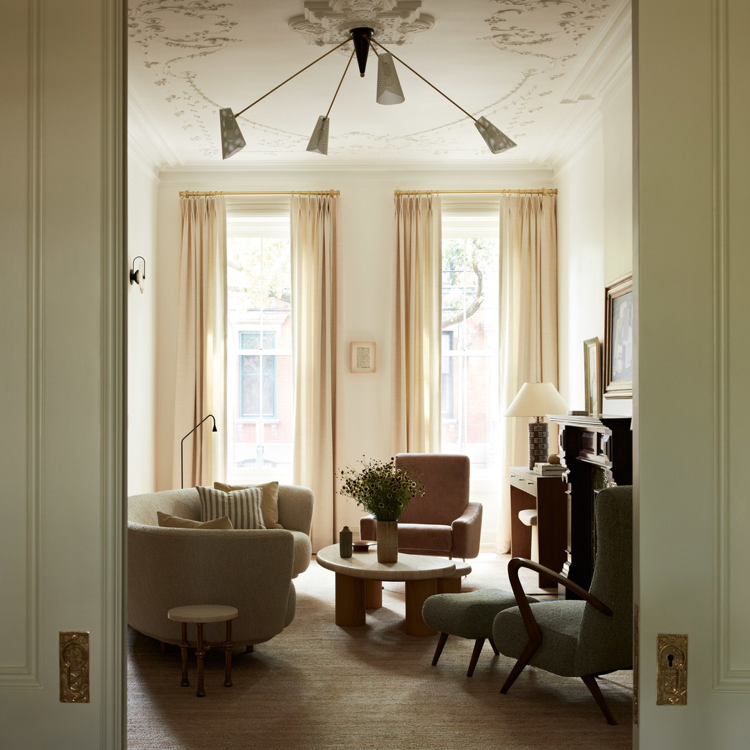 a living room filled with furniture and a ceiling fan