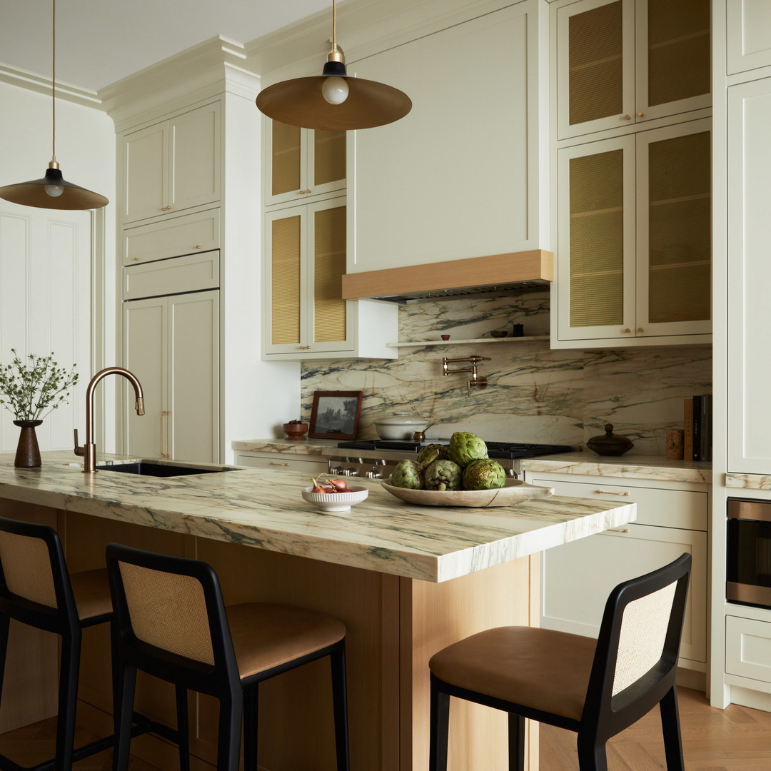 a kitchen with a center island and two stools