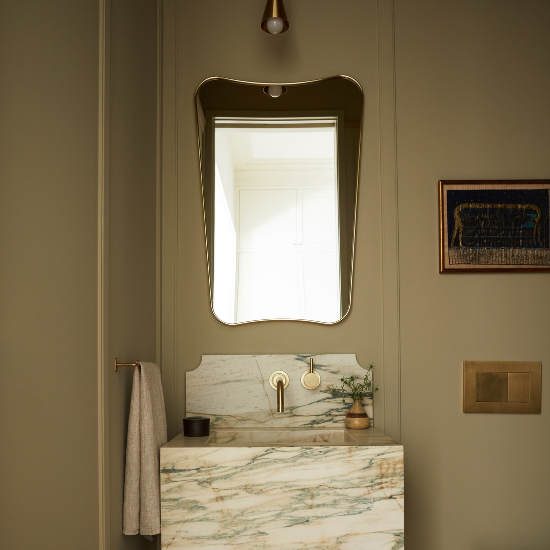 a bathroom with a sink, mirror and toilet