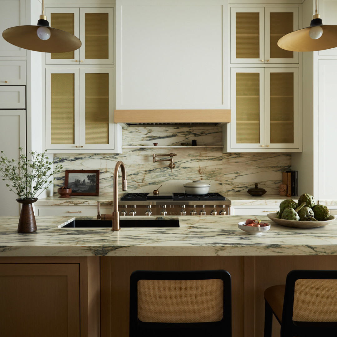 a kitchen with a marble counter top and two bar stools