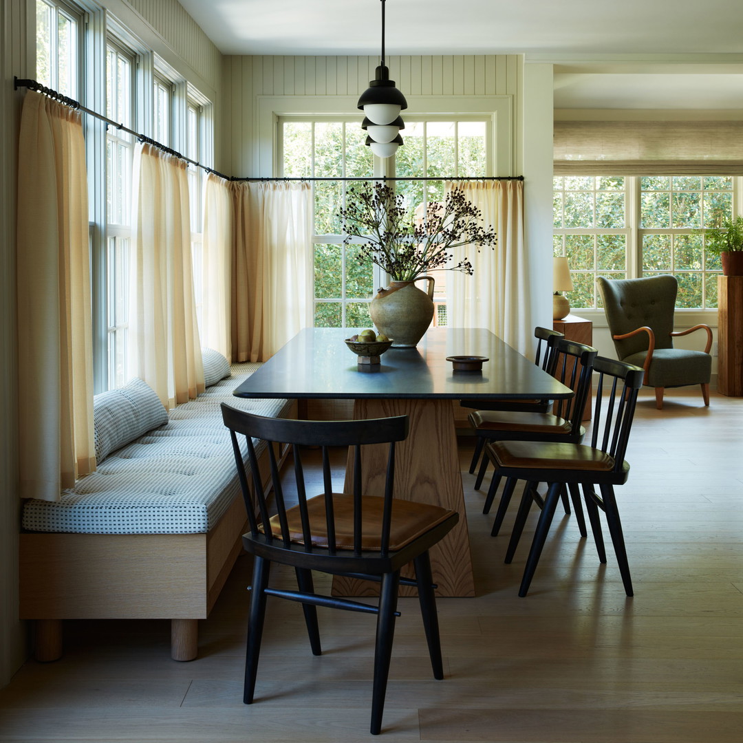 a dining room table with chairs and a bench