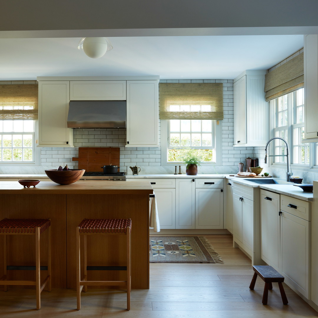 a kitchen with a center island with stools