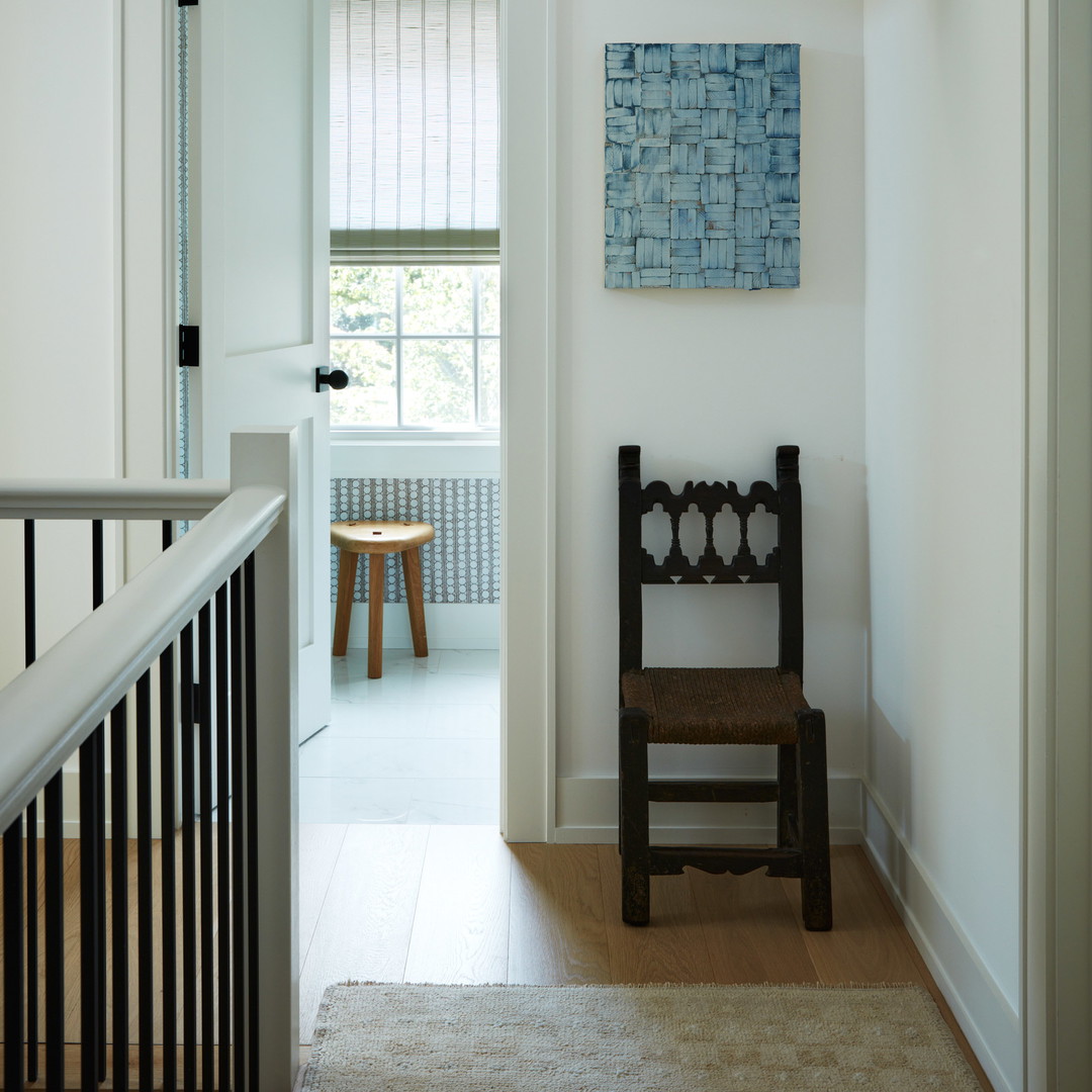 a wooden chair sitting in a hallway next to a doorway