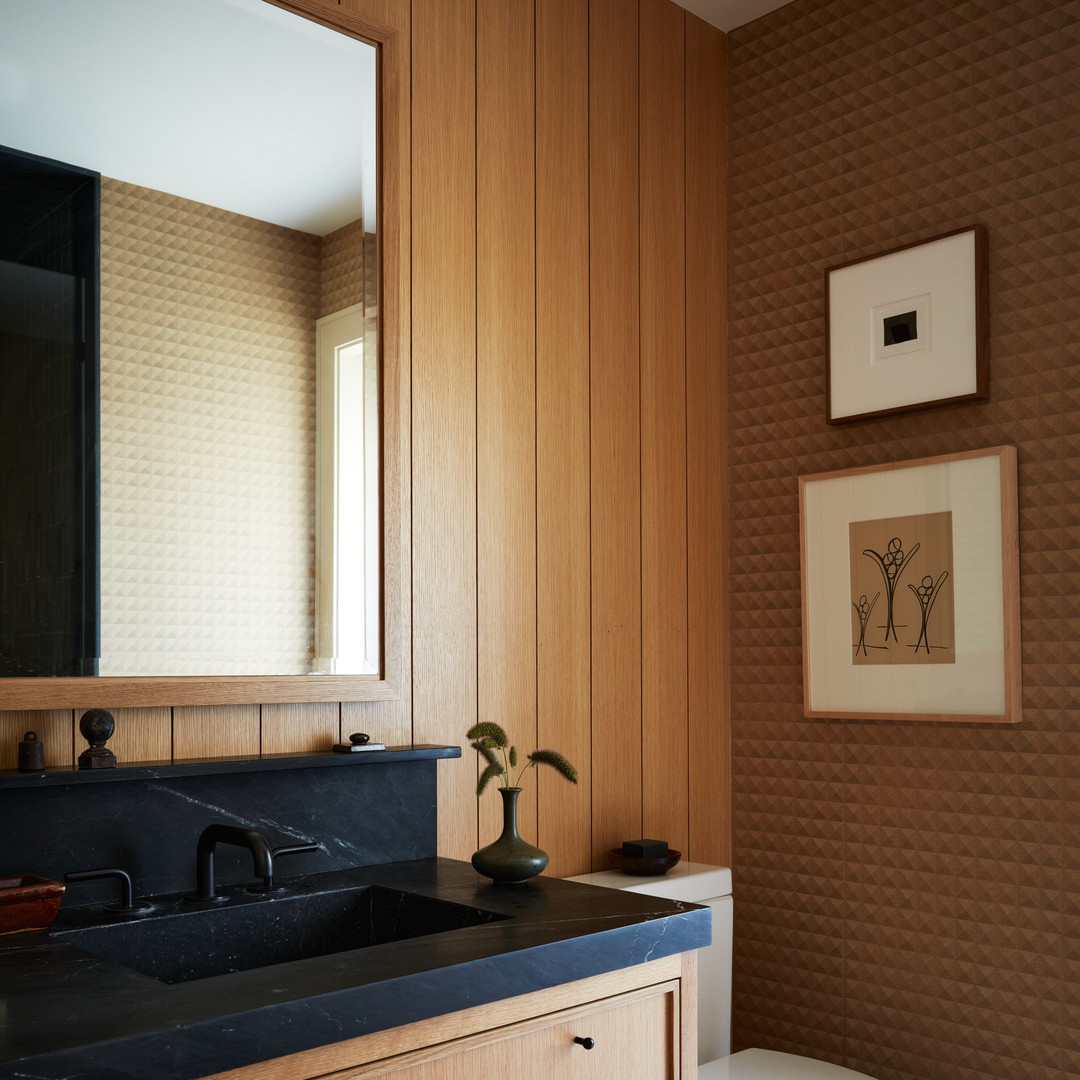 a bathroom with wood paneling and a white toilet