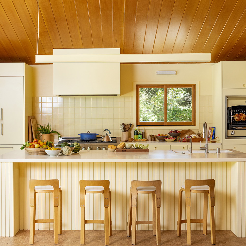 a kitchen with a center island and three stools