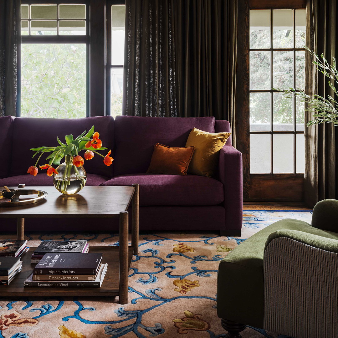 a living room filled with furniture and a large window