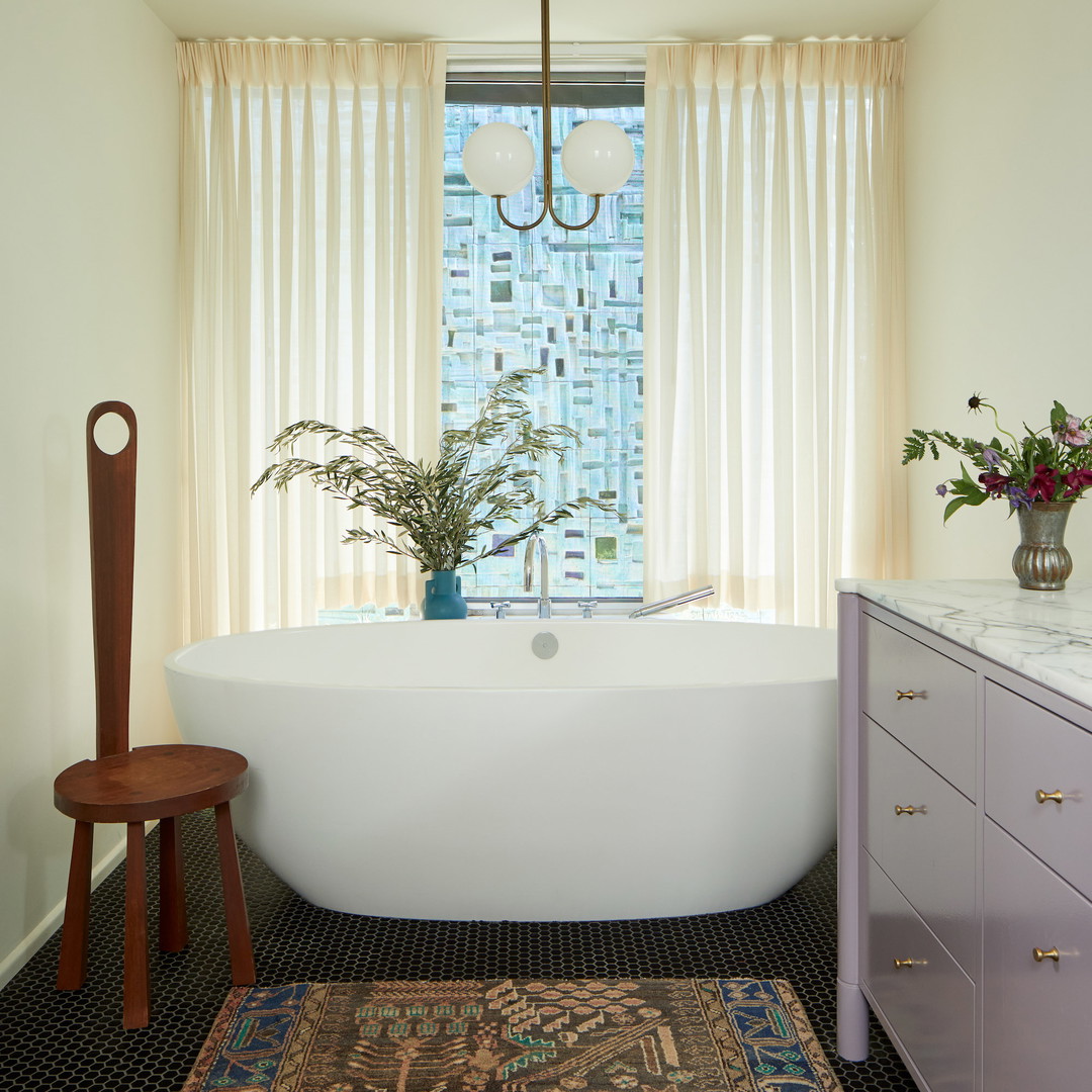 a white bath tub sitting next to a window