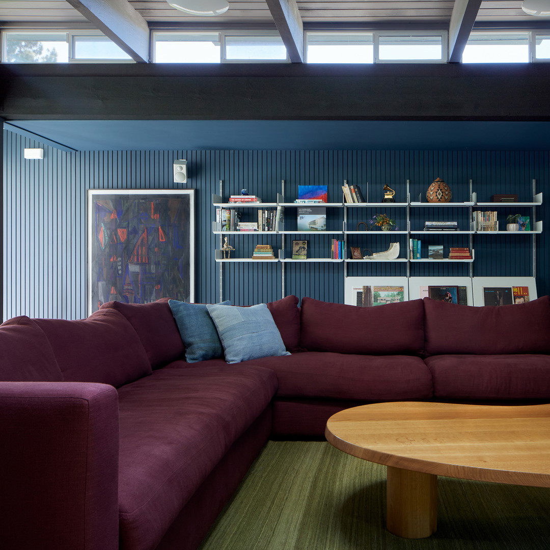 a living room filled with furniture and a large wooden table