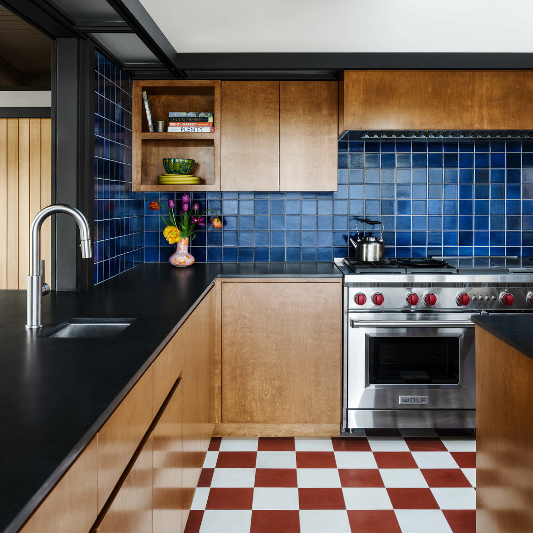 a kitchen with a checkered floor and wooden cabinets