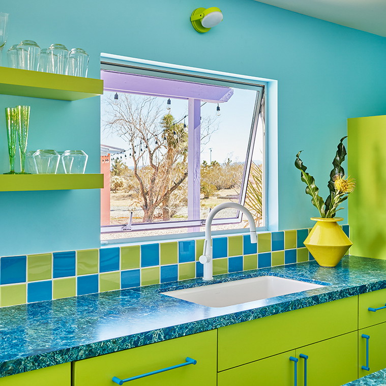 a kitchen with blue and green counter tops