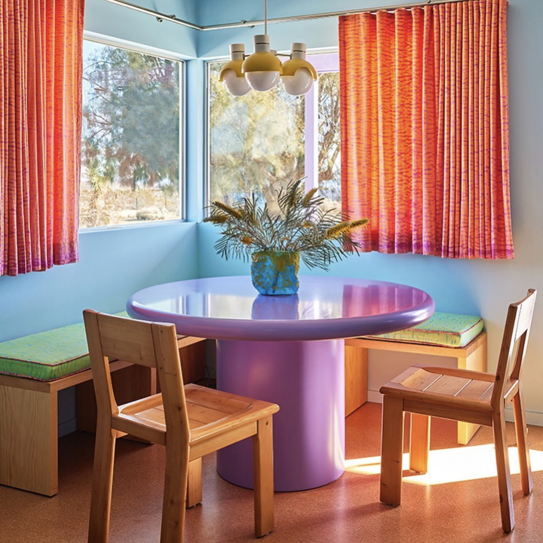 a dining room with a table and chairs