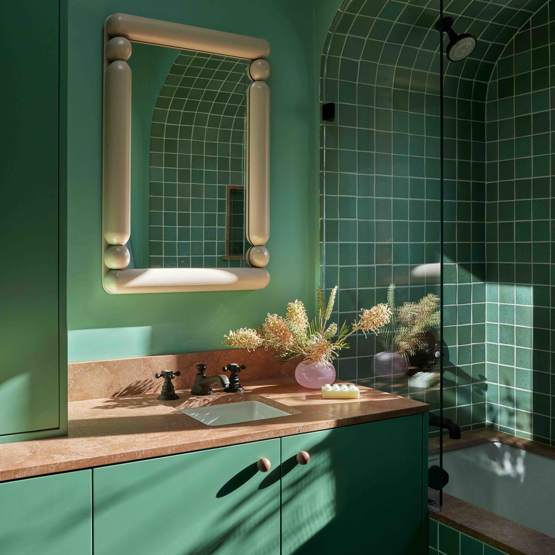 a bathroom with a sink, mirror and bathtub