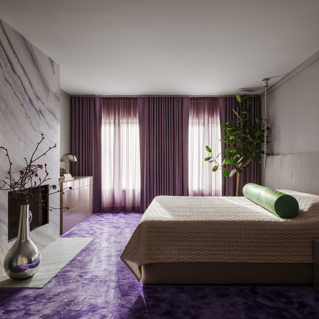 a bed room with a neatly made bed and purple carpet