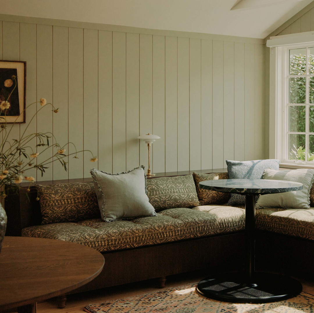 a living room filled with furniture and a large window