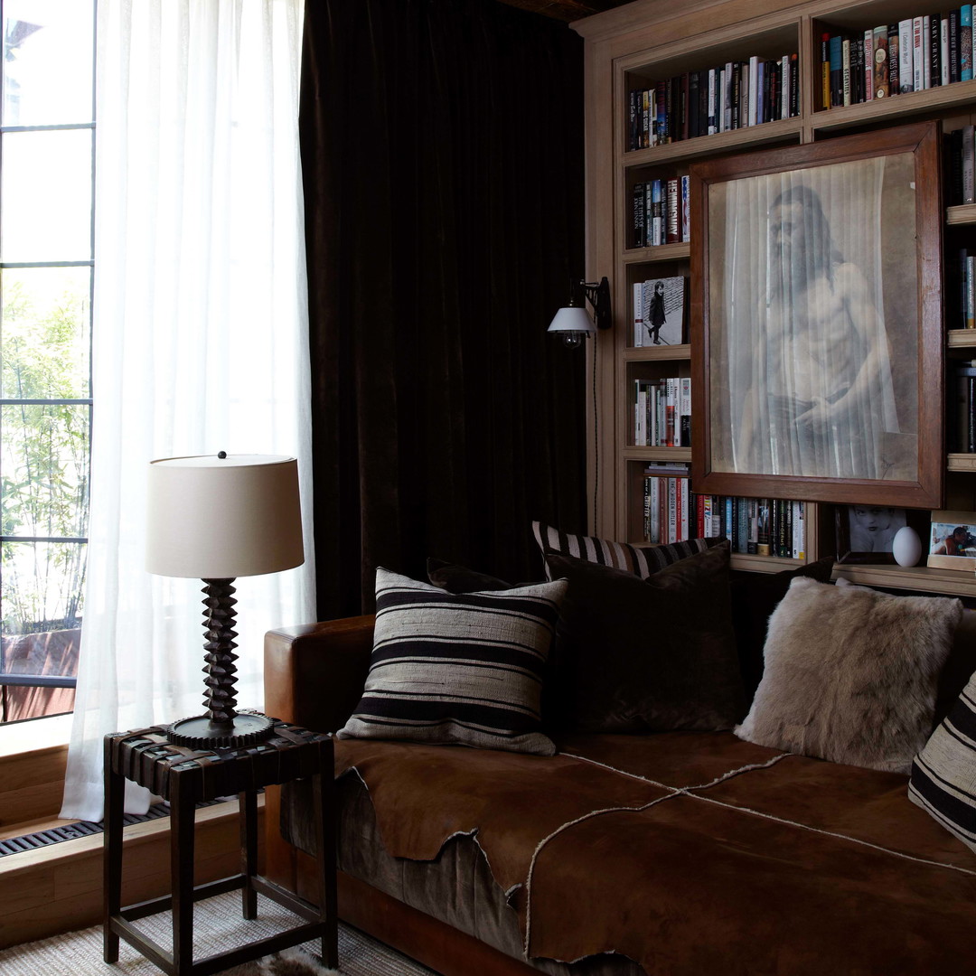 a living room filled with furniture and a large window